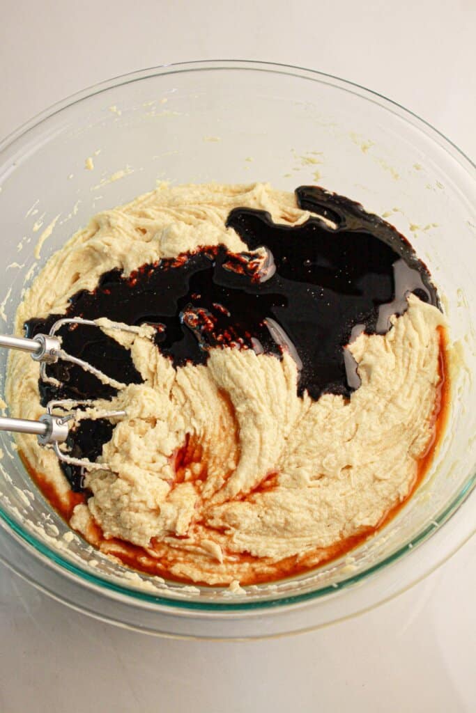 Molasses being added to butter.