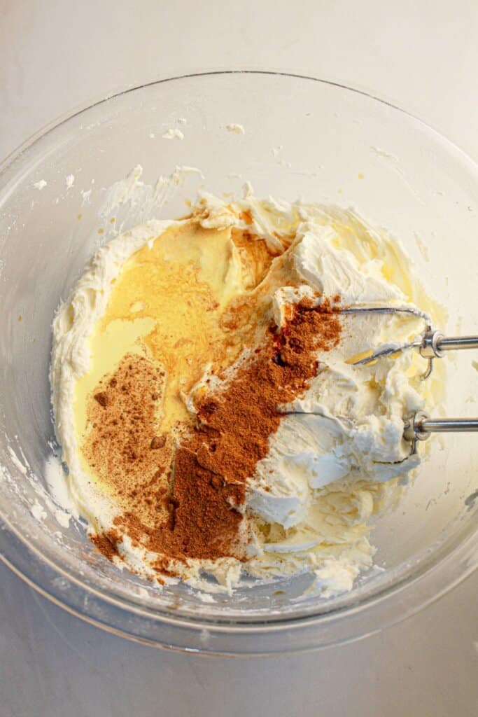 Frosting being mixed in bowl.