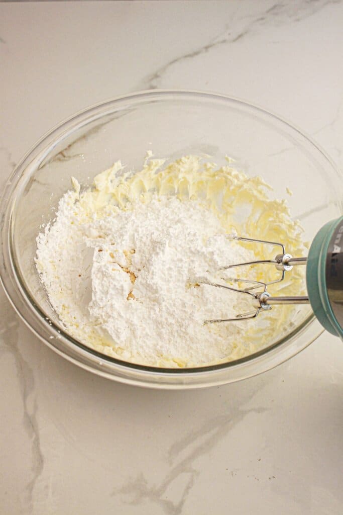 Powdered sugar being added to frosting.