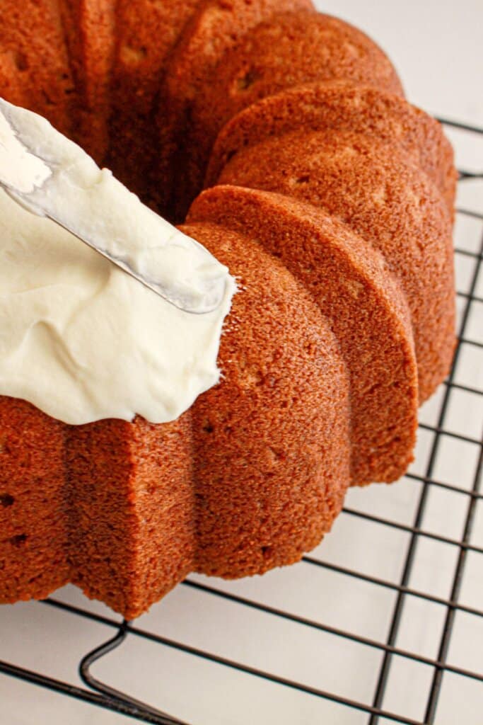 Frosting being spread on cake.