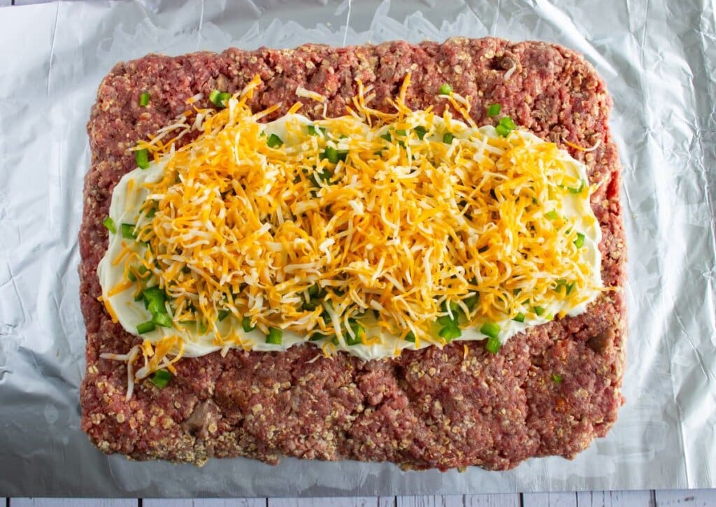 Cheese being added to meat.