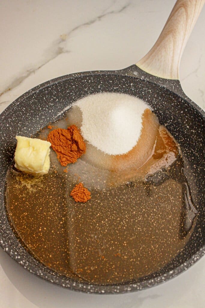Butter, sugar, water, and cinnamon in a skillet.