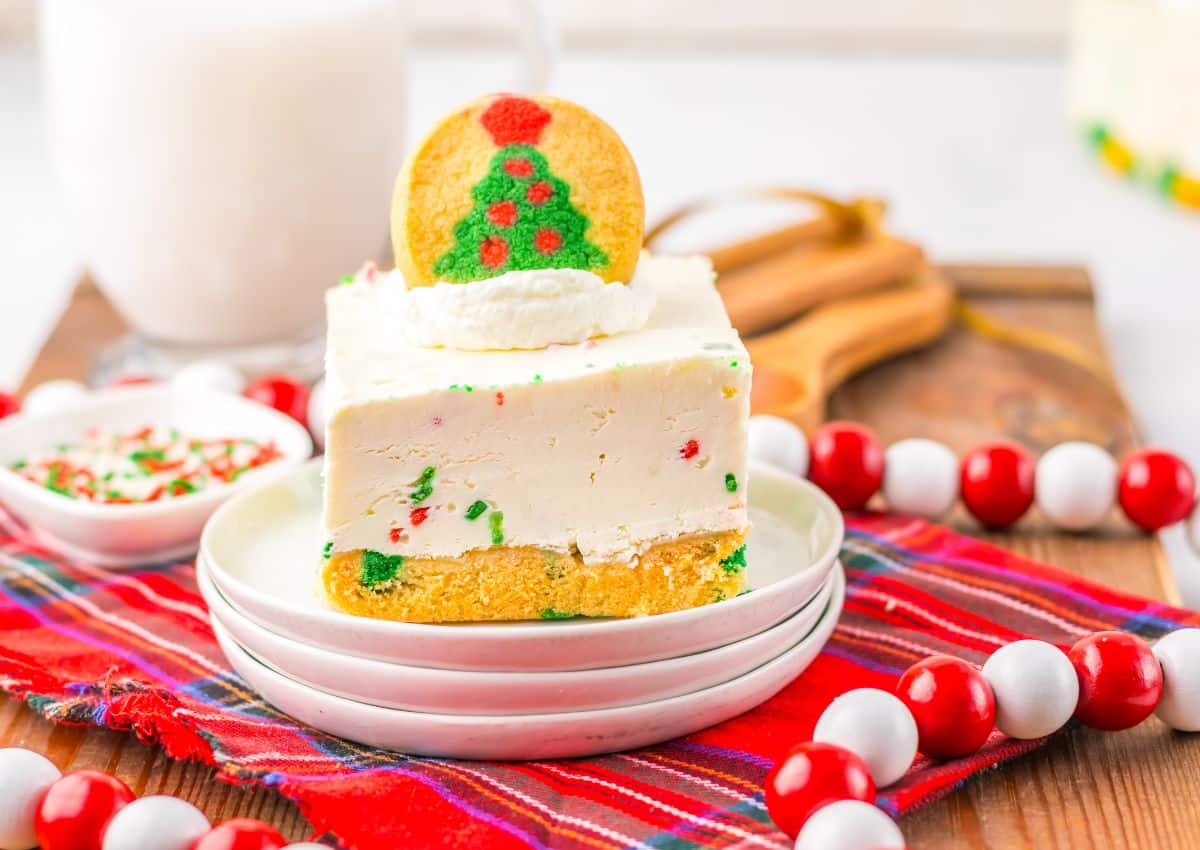 Slice of Christmas cheesecake bar on a small plate.