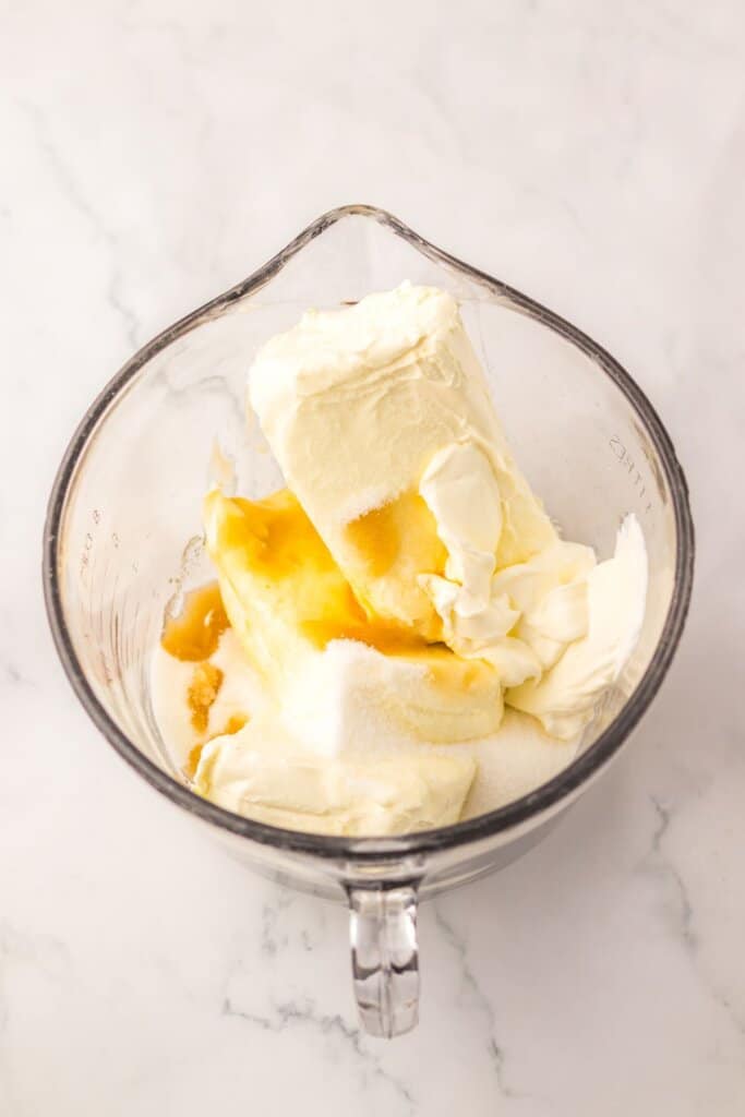 Cream cheese, sugar, and vanilla being mixed.