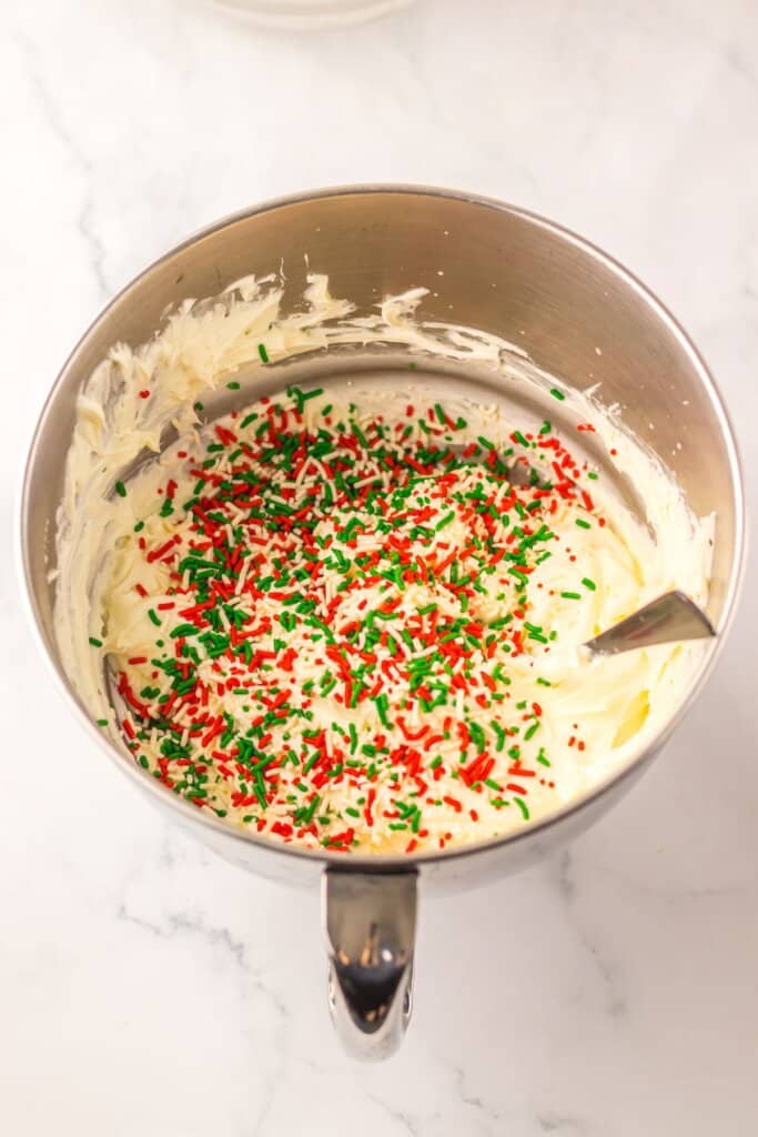 Sprinkles being added to cheesecake filling.
