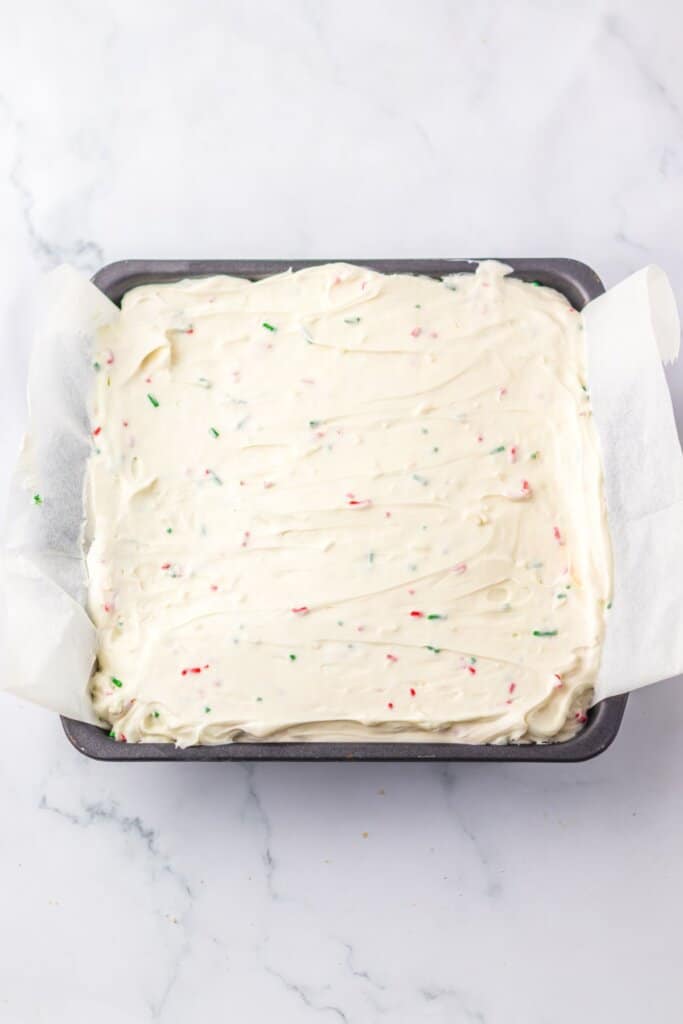 Filling being added to baking dish.