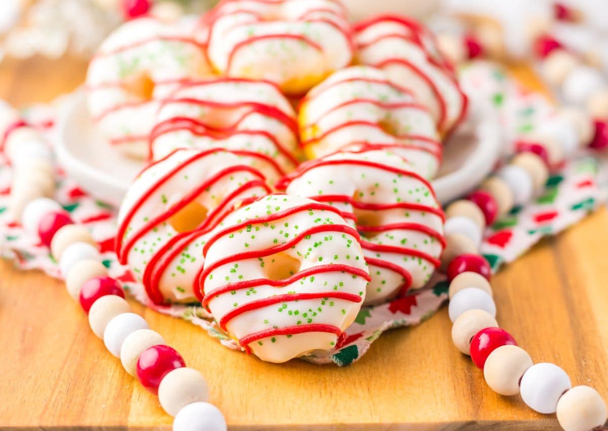 Christmas tree cake donuts on a wooden cutting board.