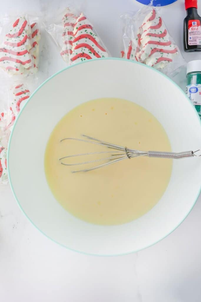 Pudding being mixed in a bowl.