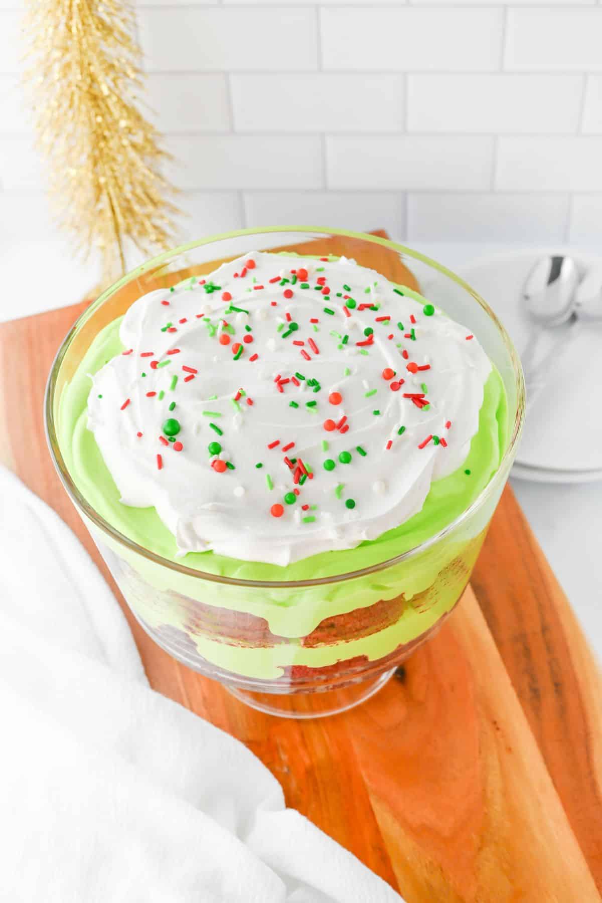 Glass bowl filled with trifle and topped with sprinkles.