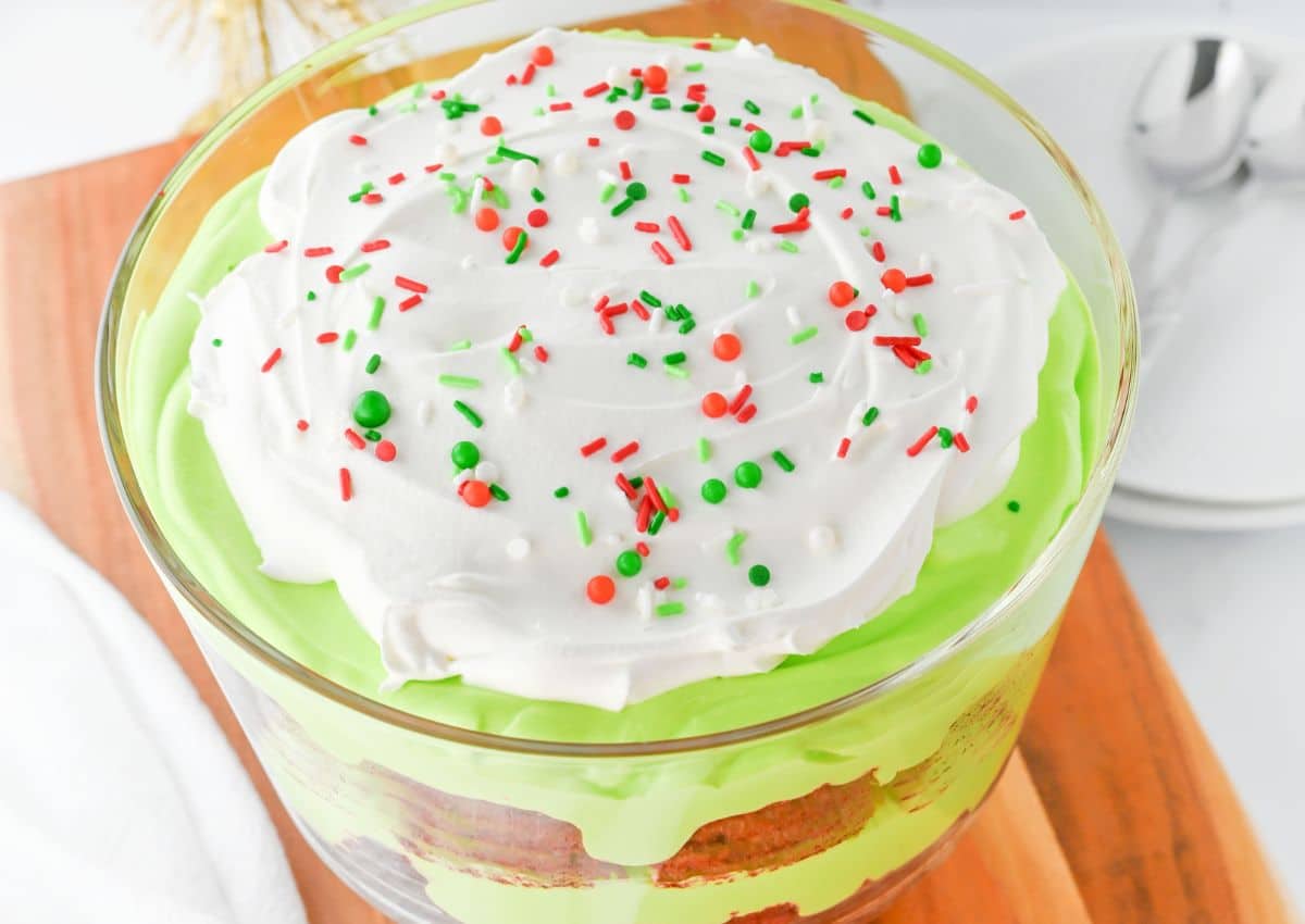 Glass bowl filled with trifle and topped with sprinkles.