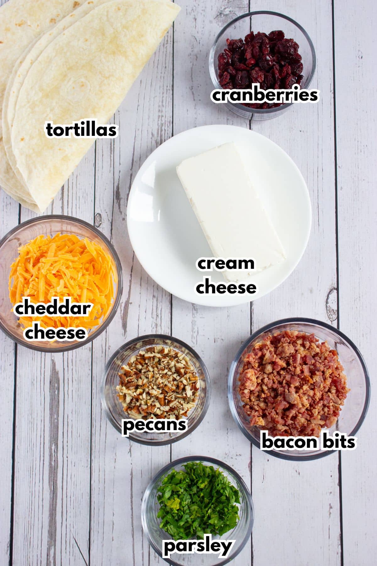 Bowls of ingredients labelled with texts on a counter.