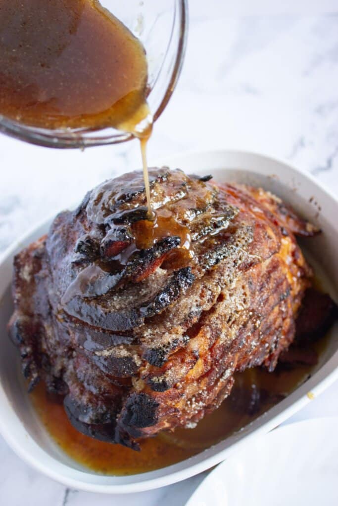 Glaze being poured on ham.