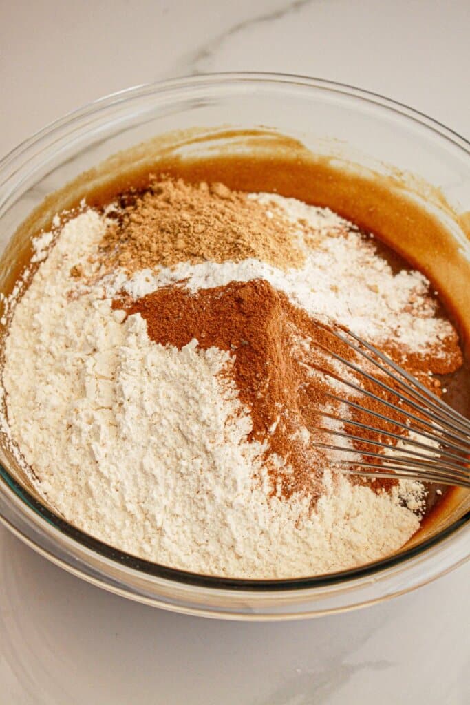Dry ingredients being mixed in a glass mixing.