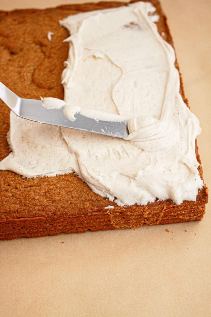 Frosting being spread on a brownies.