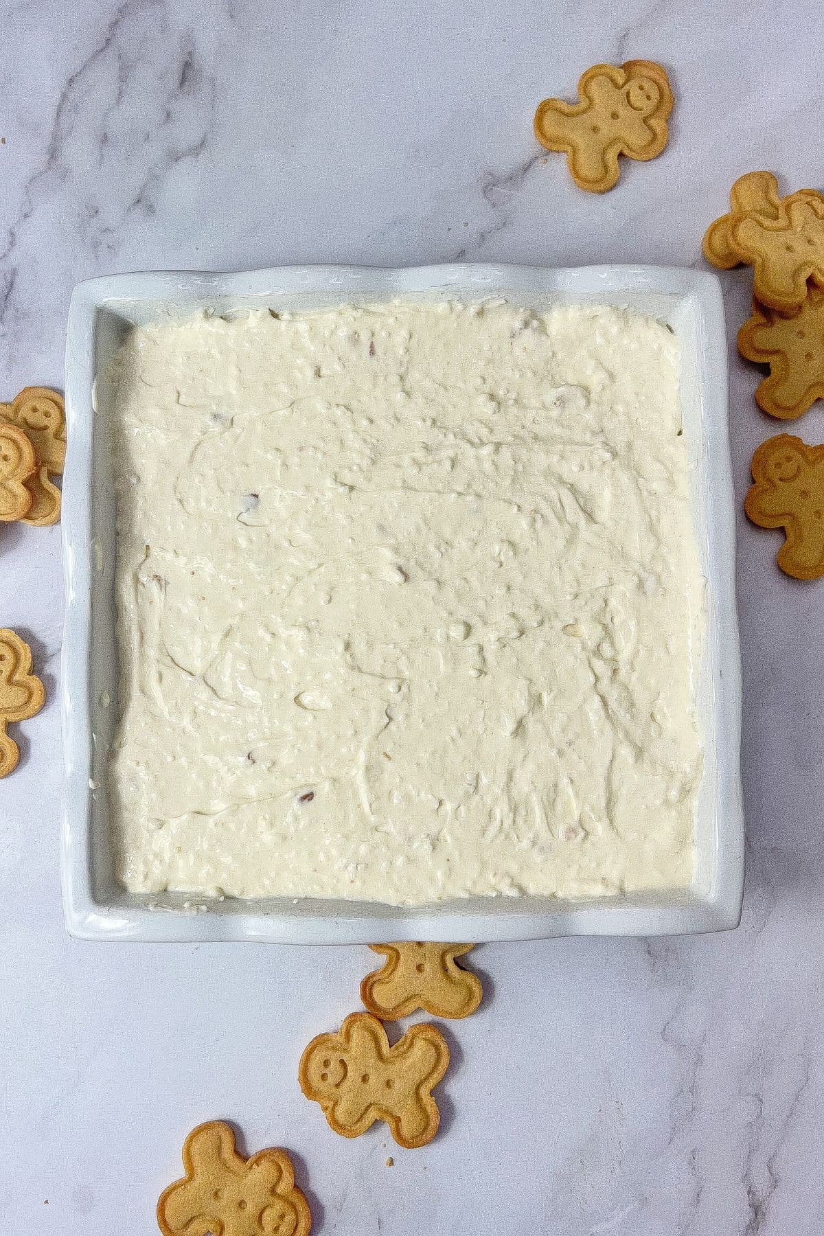 Cheesecake being spread into bars.