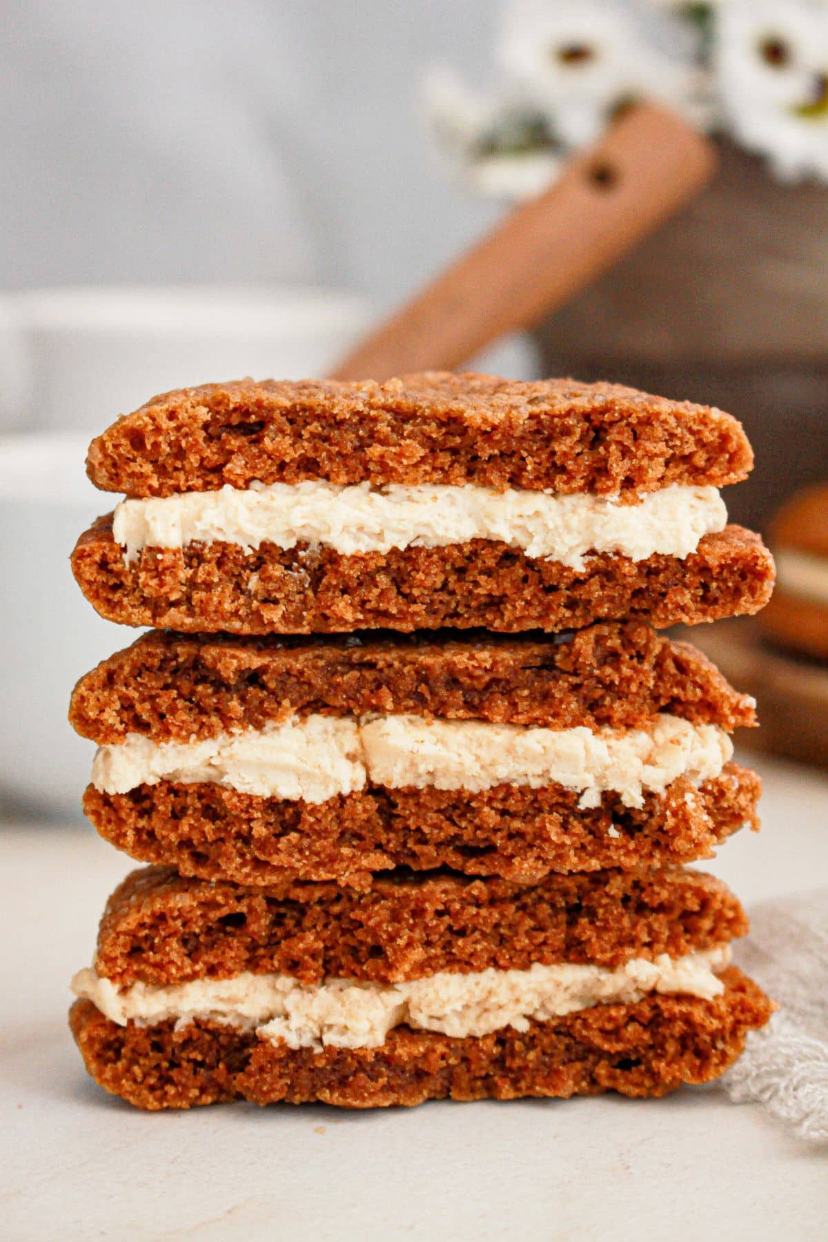 Gingerbread latte cookies stacked on a table.