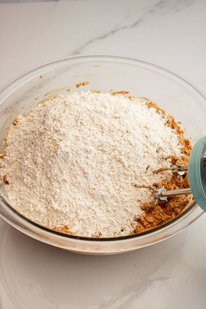 Dry ingredients being added to wet ingredients.