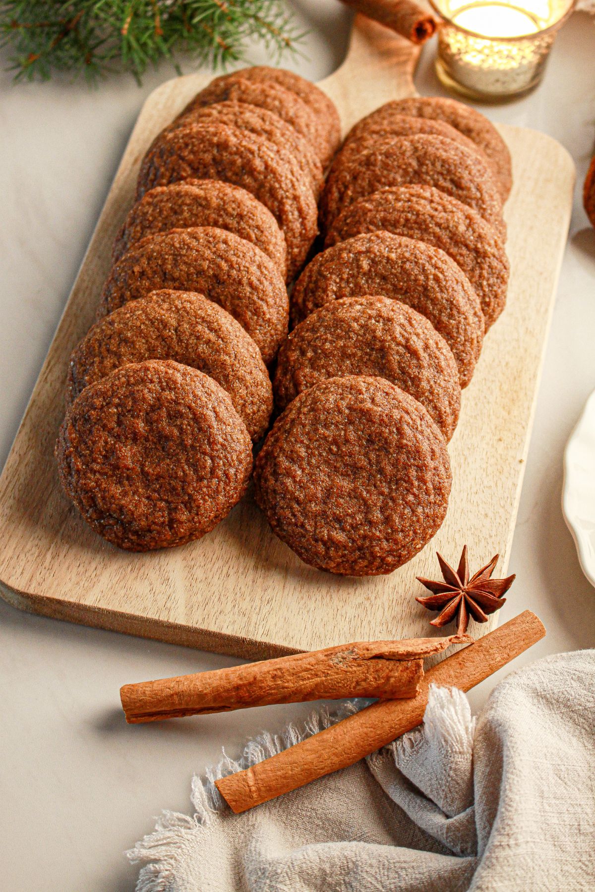 Gingerbread molasses cookies on a wooden cutting board.