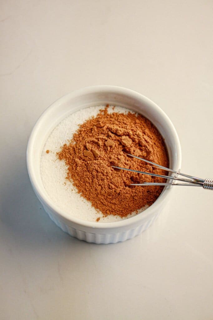 Sugar and cinnamon being mixed together.