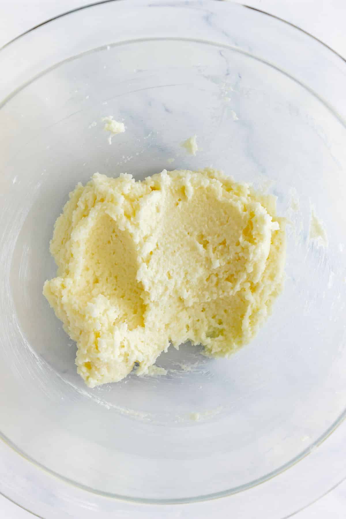 Butter in a glass mixing bowl.