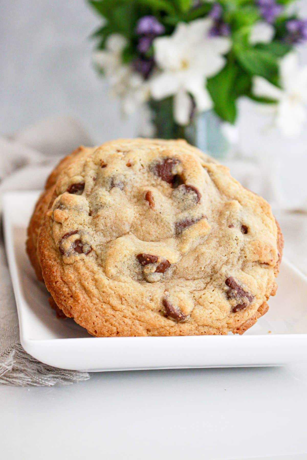Chocolate chip cookies on a serving platter in a row.