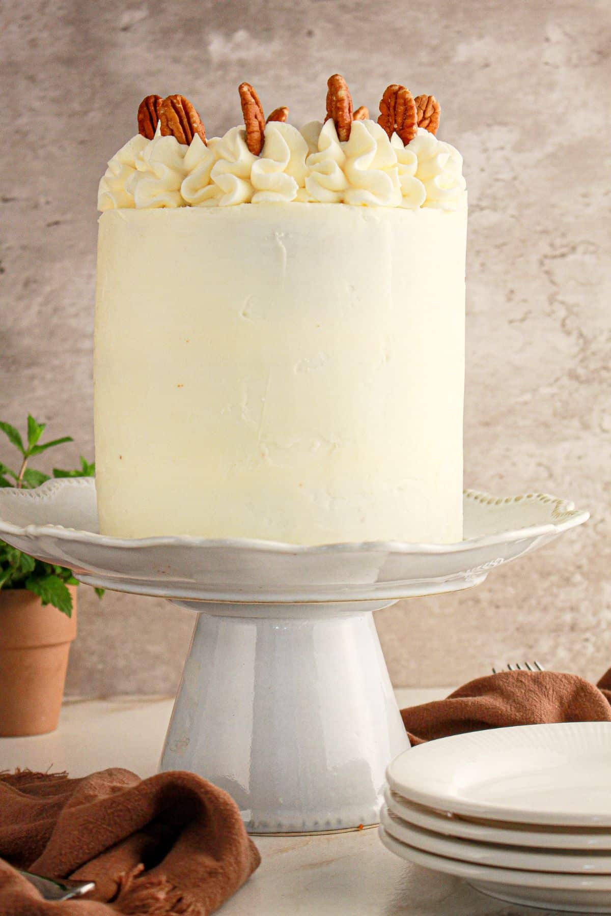 Pecan pie cake on a white cake stand.