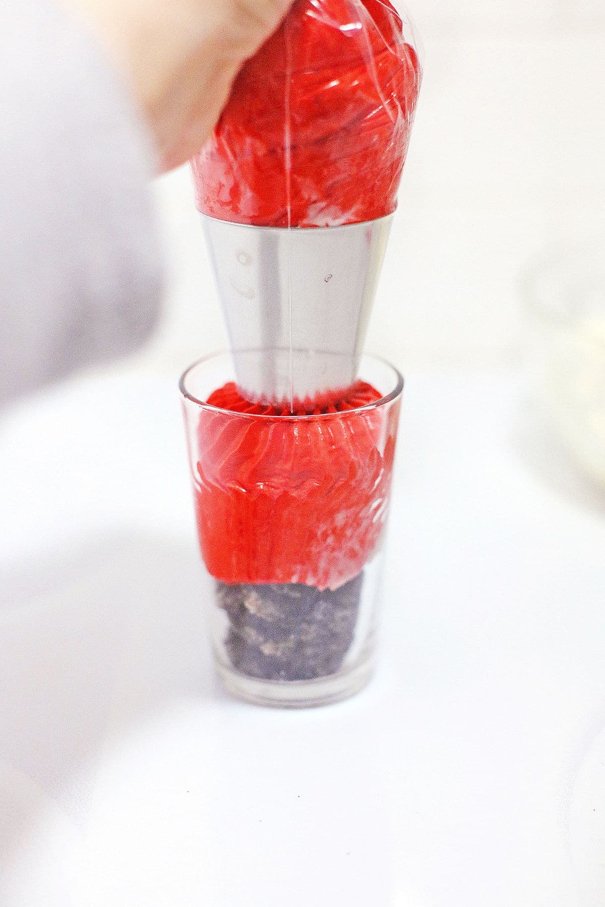 Cheesecake being added to a glass.