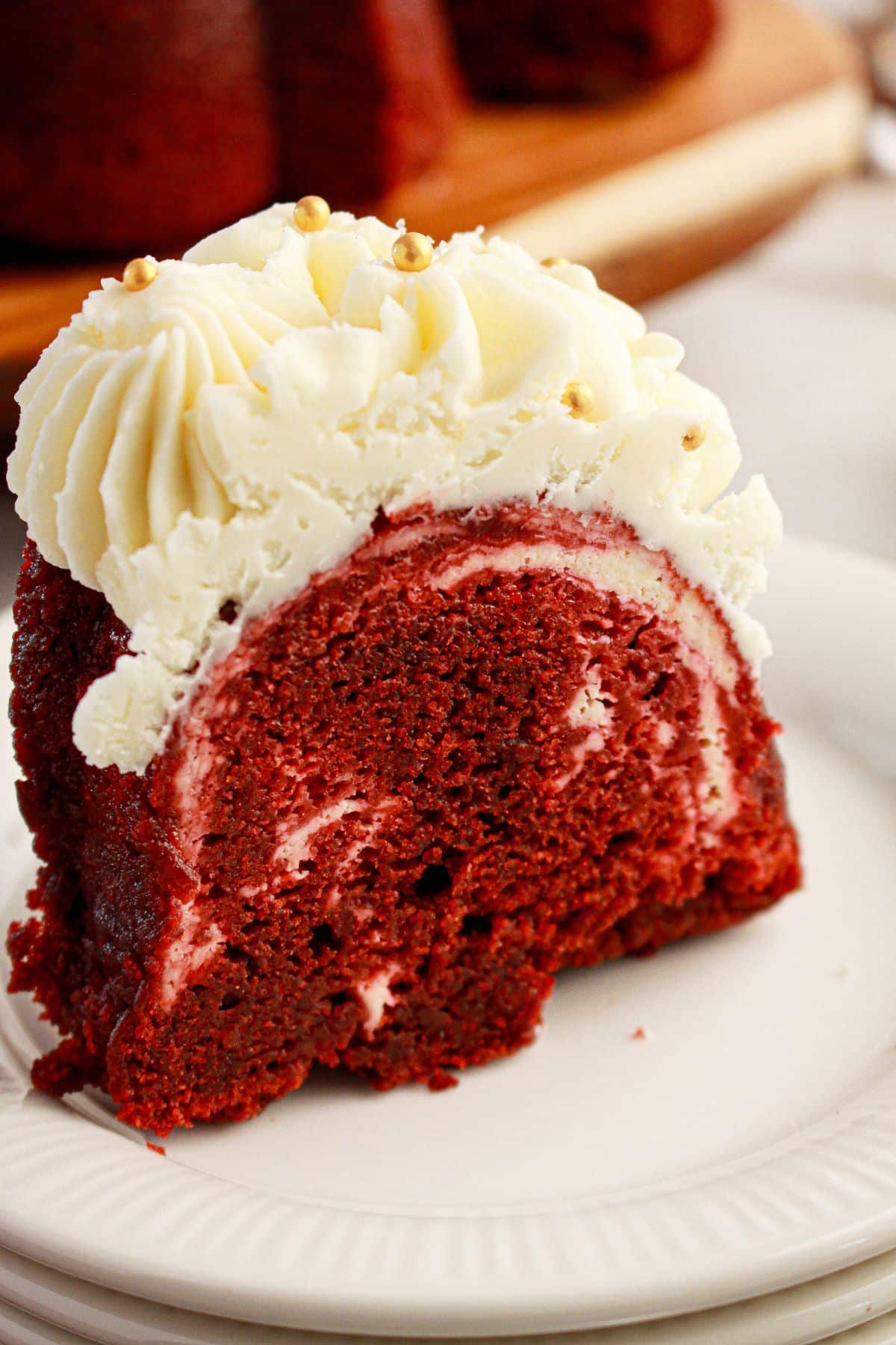 Slice of red velvet bundt cake on a plate.