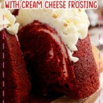 Slice of red velvet bundt cake being removed from a board.
