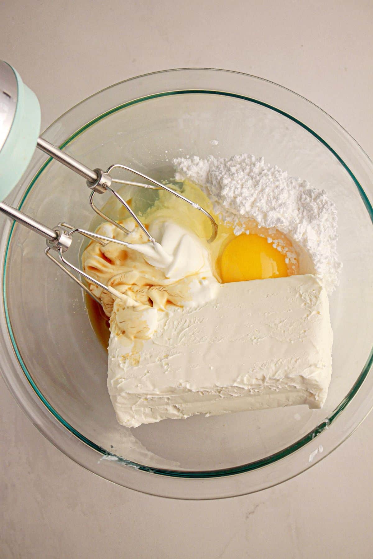 Cream cheesecake filling in a glass bowl.