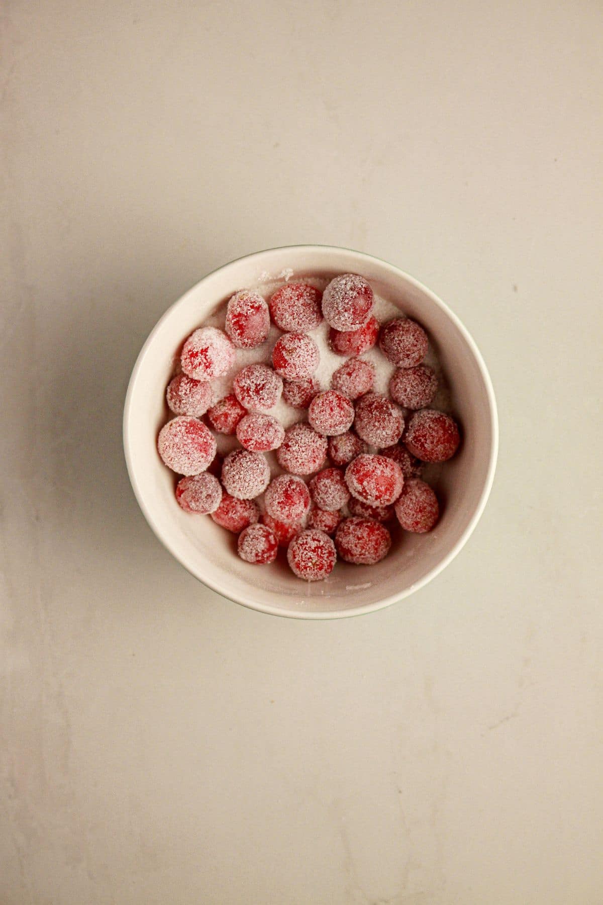 Sugared cranberries in a small bowl.
