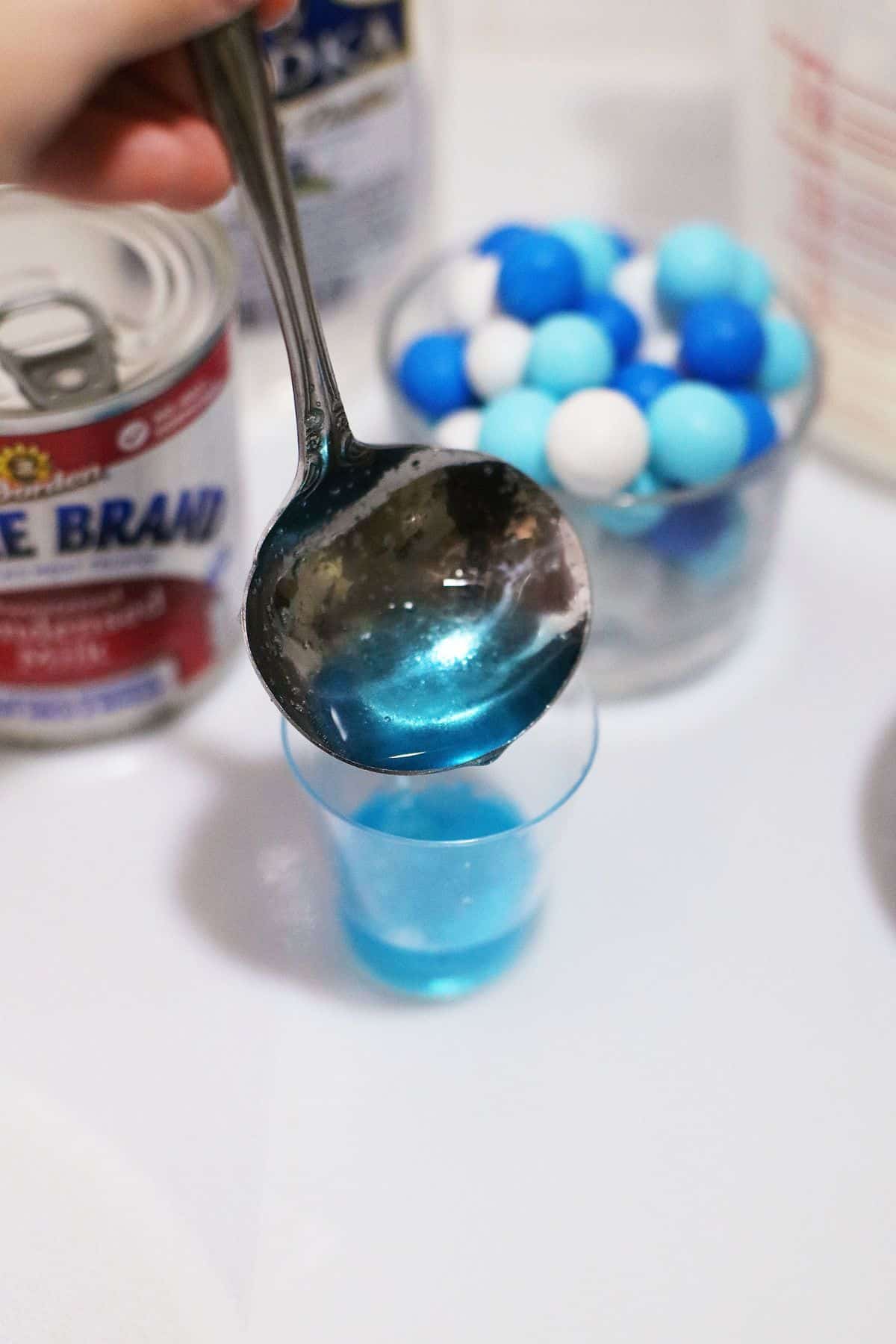 Gelatin beign added to a glass.