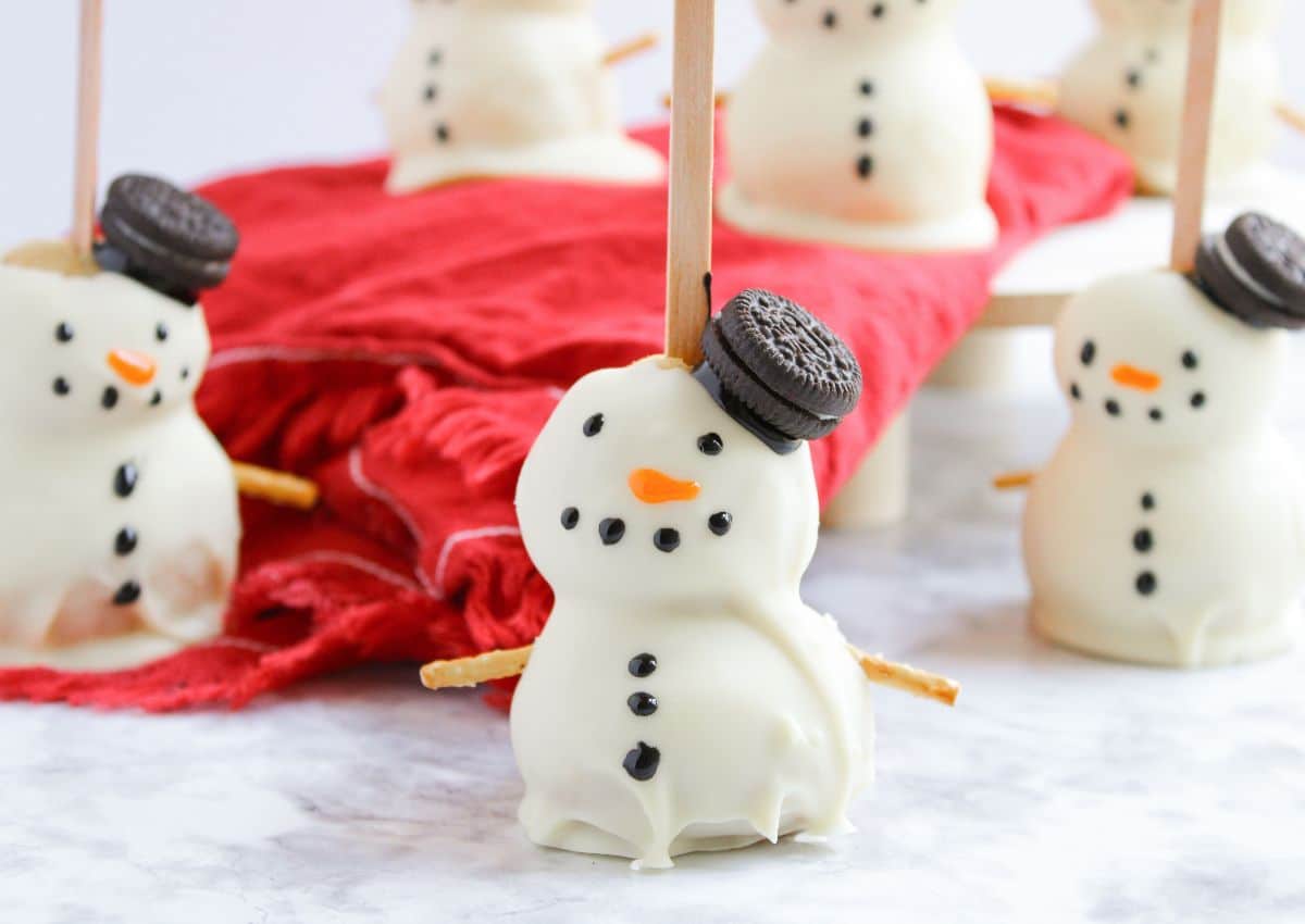 Snowman cake balls on a counter.
