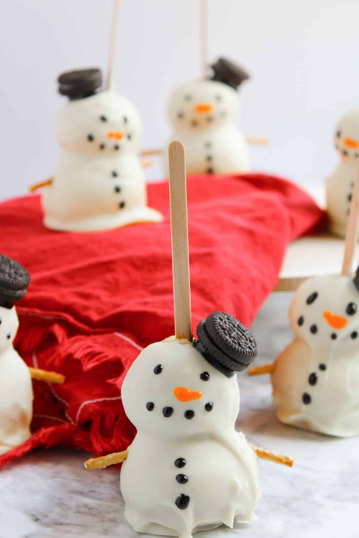 Snowman cake balls on a counter.