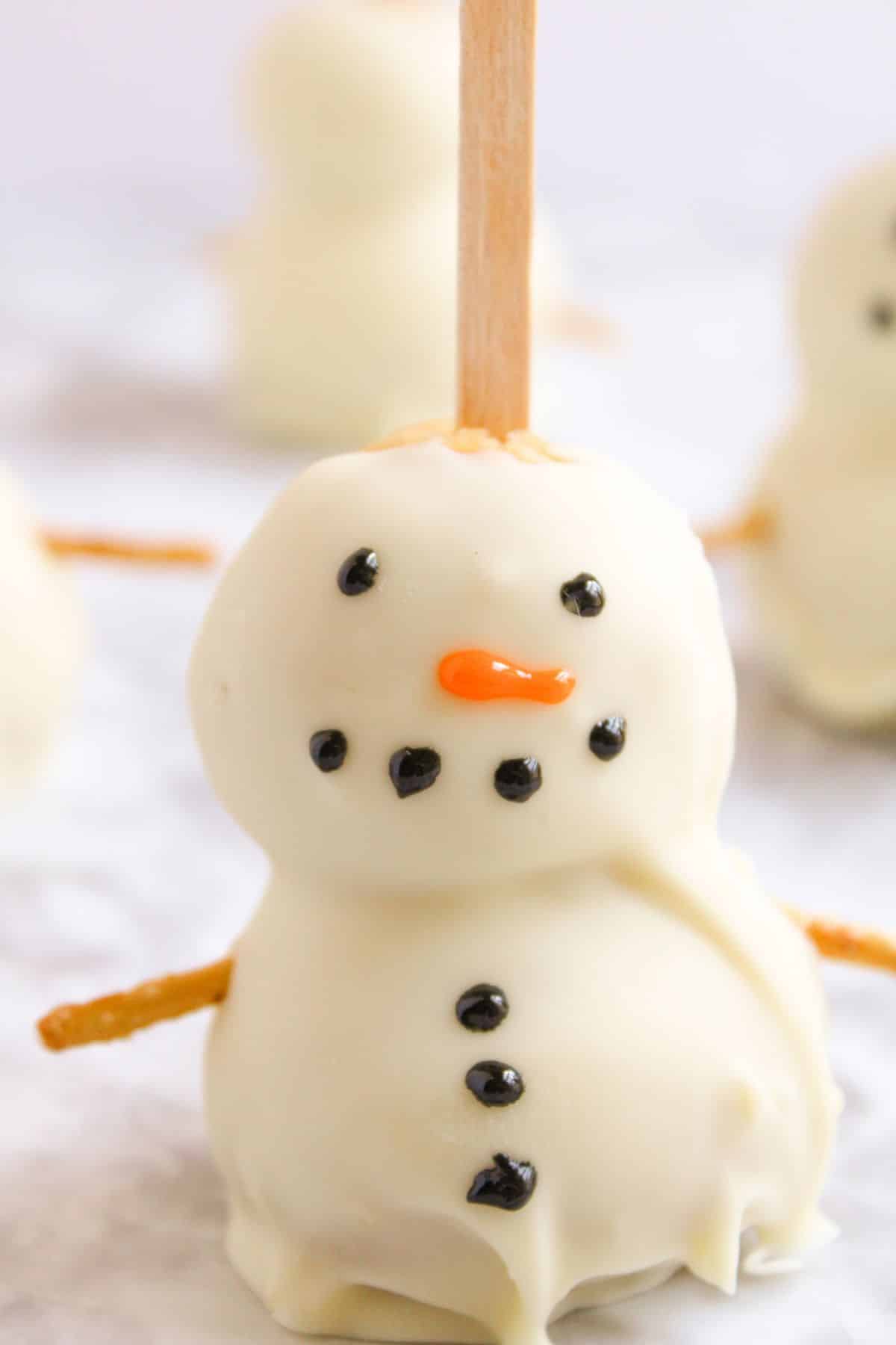 Buttons being added to cake pop.
