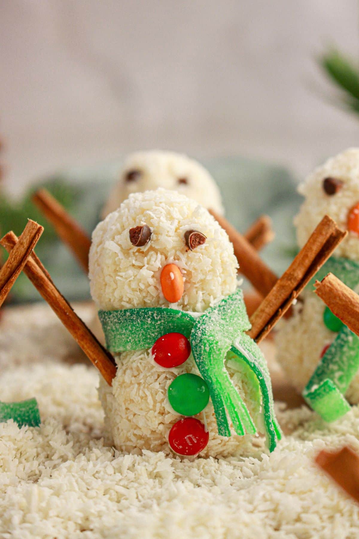 Snowman truffles on a counter.