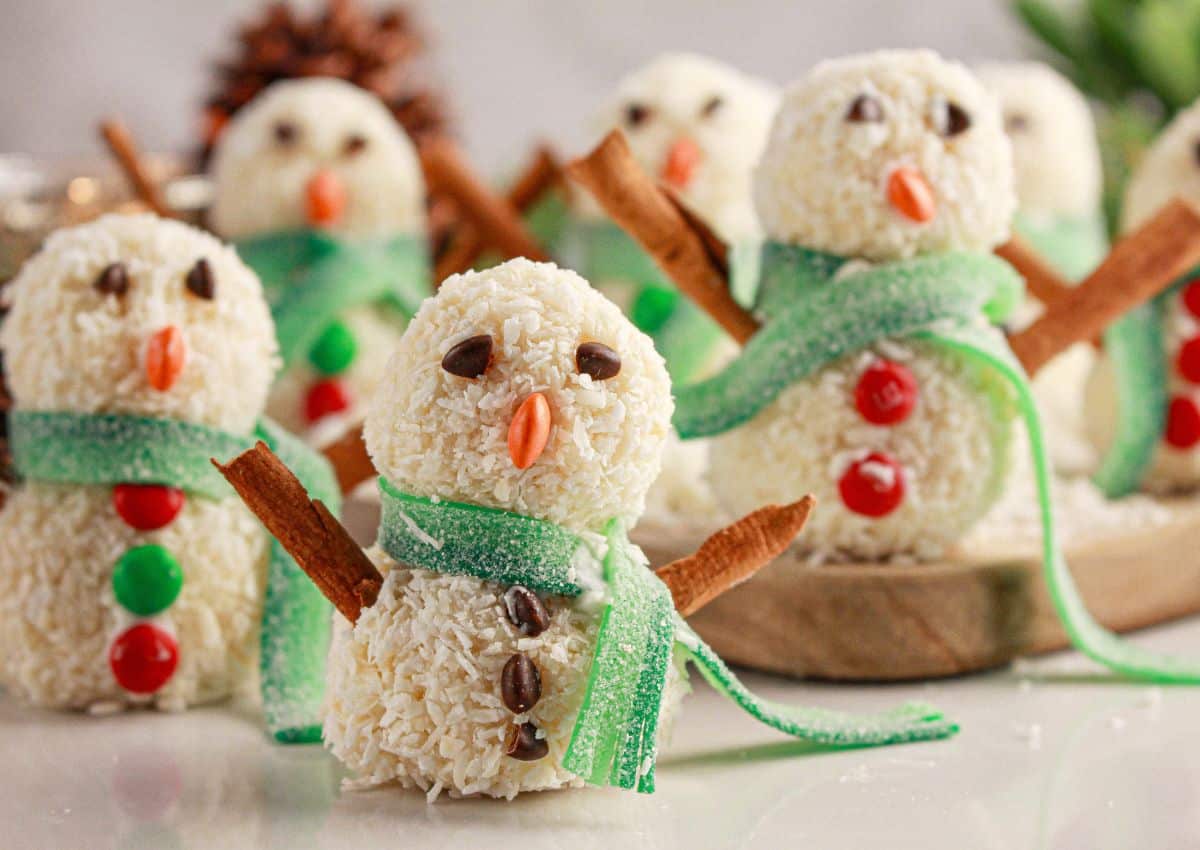 Snowman truffles on a counter.