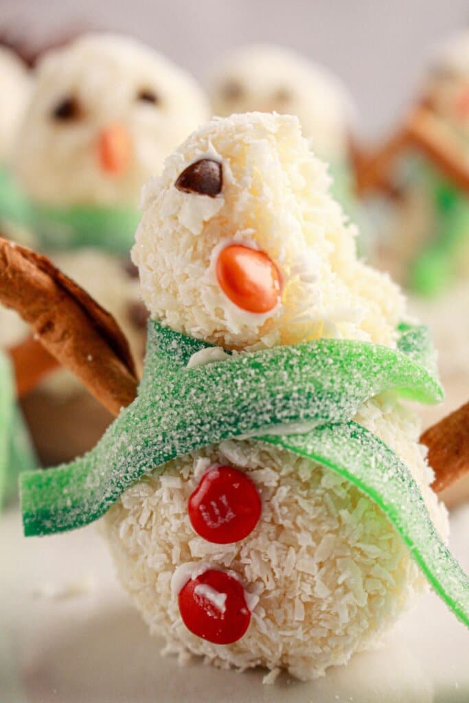 Snowman truffles on a counter.