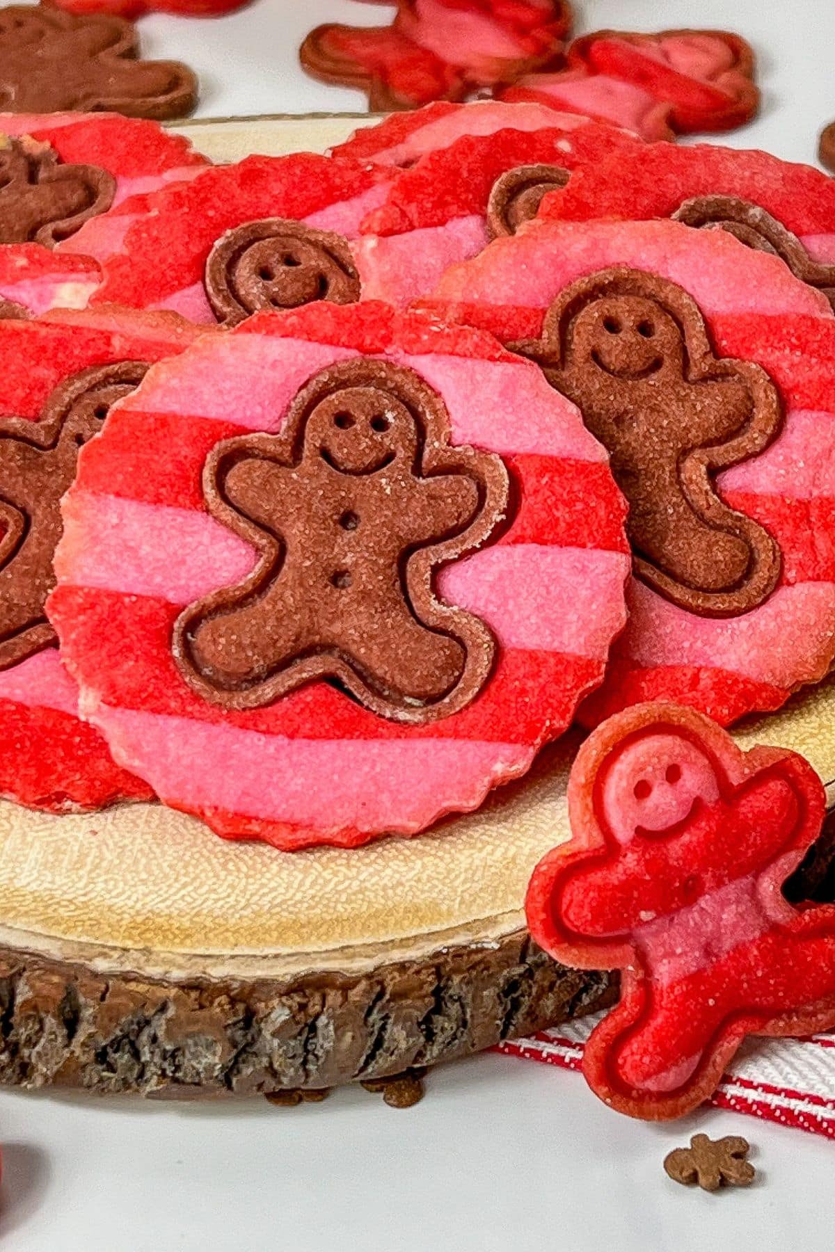 Striped gingerbread men cookies on cutting board.