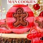 Striped gingerbread men cookies on cutting board.