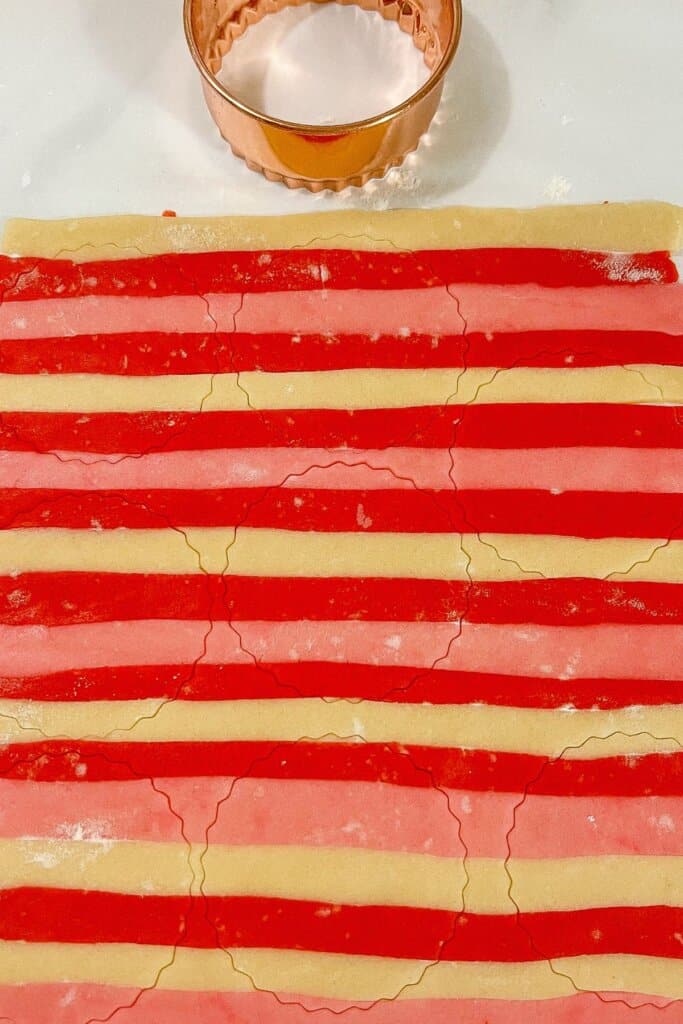 Cookie dough being cut out.