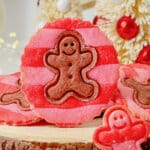 Striped gingerbread men cookies on cutting board.