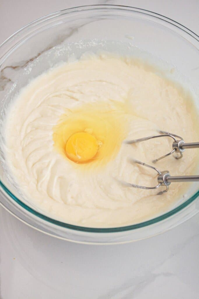 Egg being added to cake batter.