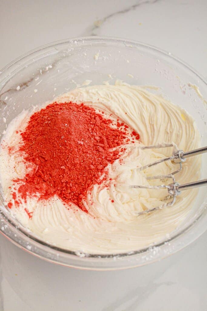 Freeze-dried strawberries being added to icing.