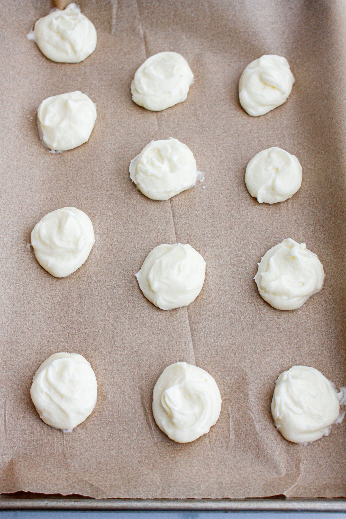 Cream cheese mixture hardened on a baking sheet.