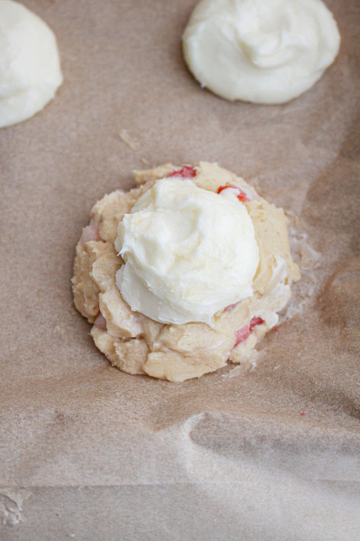 Cheesecake center being added to cookie dough.