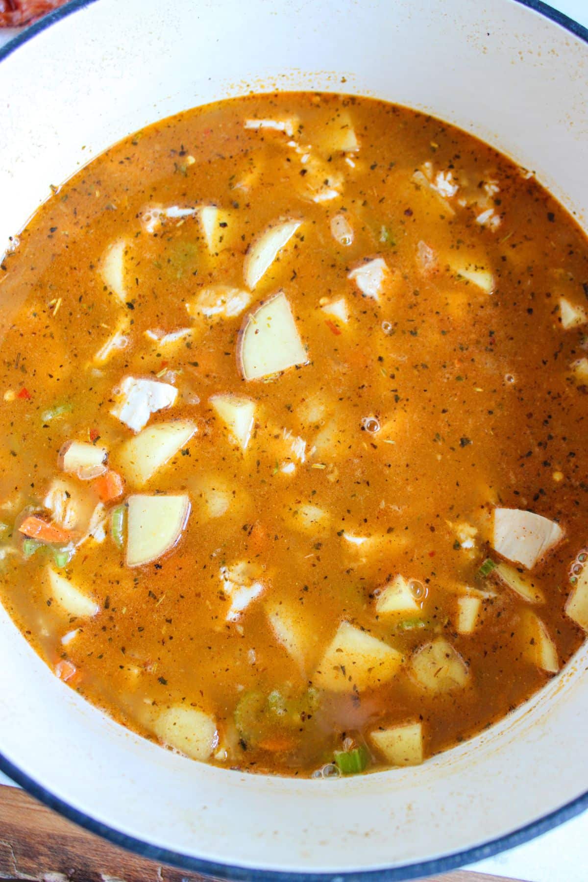Vegetables being added to large pot.