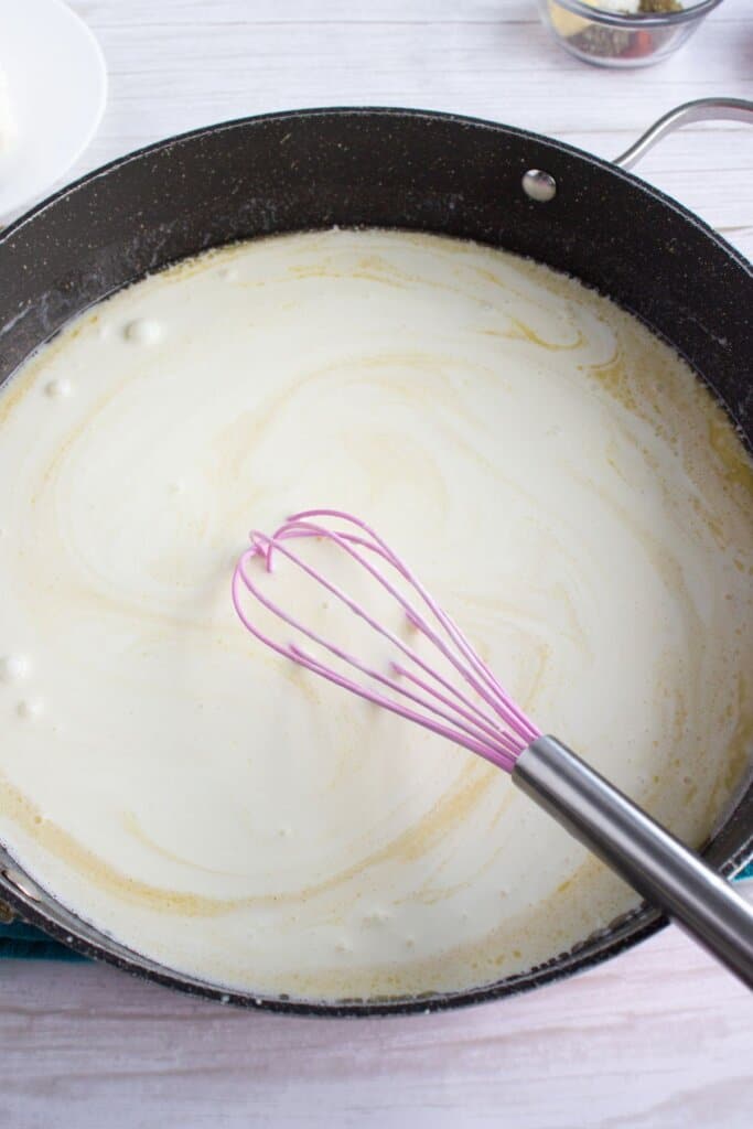 Roux being cooked in a large skillet.