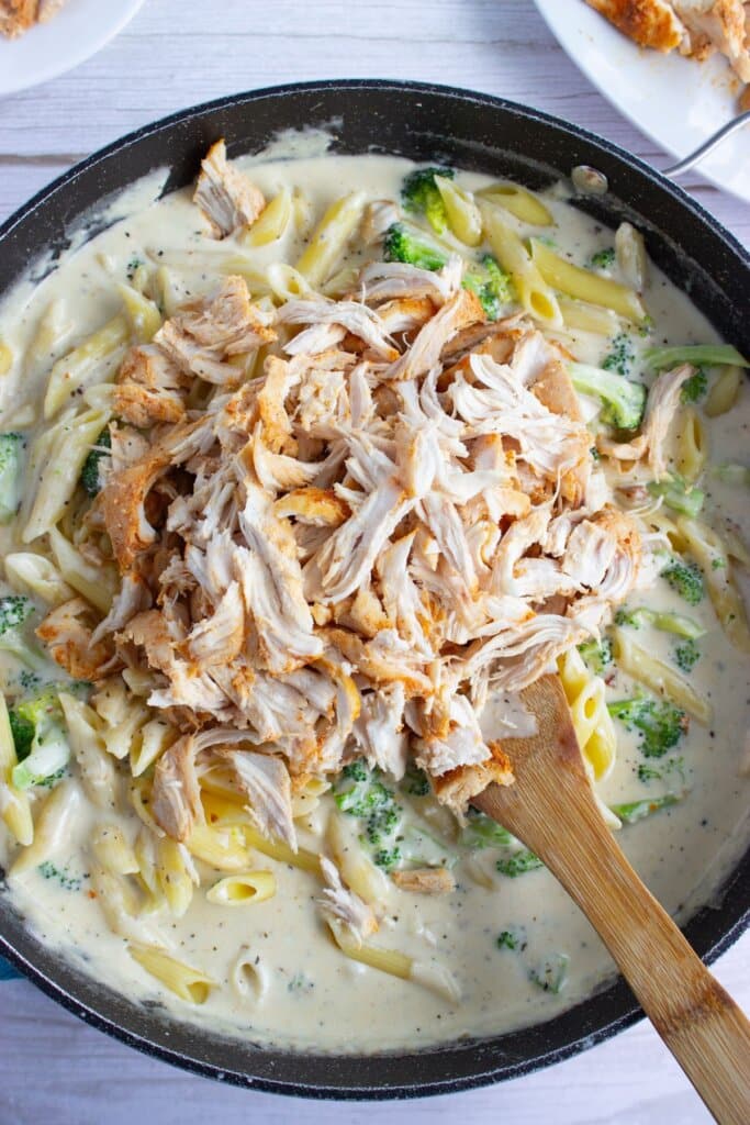 Chicken being added to skillet.