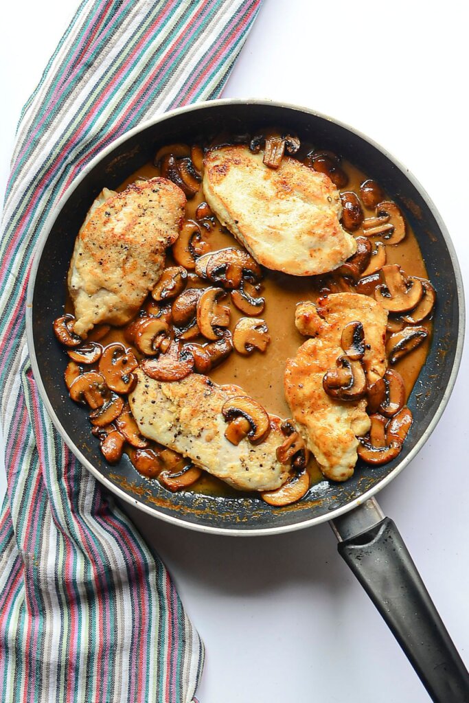 Mushrooms and sauce in a skillet.